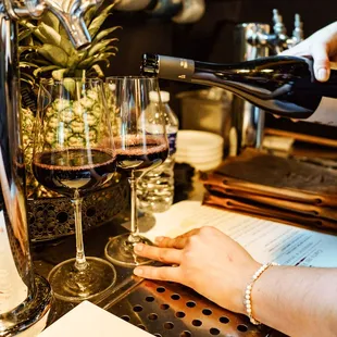 a woman pouring a glass of wine