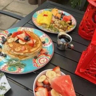 a plate of pancakes with fruit on it