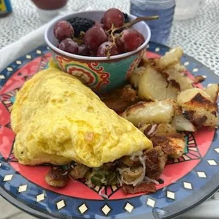 an omelet with a bowl of fruit