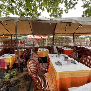tables and chairs under a canopy