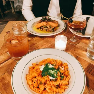 Fusilli Alla Napoletana and Salmon (in the background). Left is Off the Wal(Nut) drink and right is a Manhattan cocktail