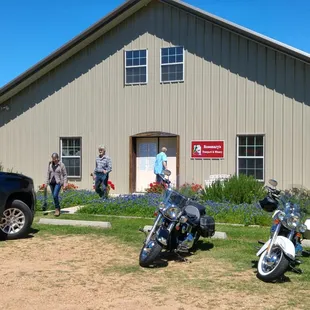 two motorcycles parked in front of a building