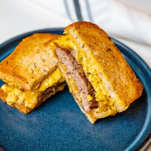 a grilled cheese sandwich on a blue plate