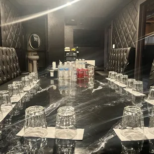 a long table with glasses of water on it