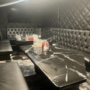 a black leather booth with a marble table