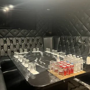 a table with empty glasses and bottles