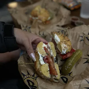 a person holding a sandwich