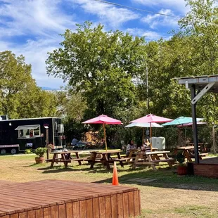 a picnic area with tables and umbrellas
