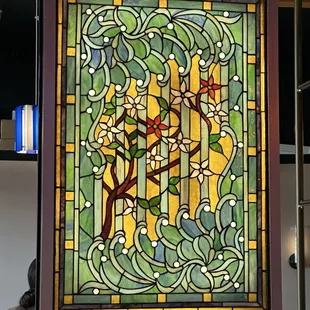 Stain glass window behind the bar.