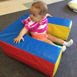 My daughter enjoying sitting in the infant room. This chair is a blessing in helping her develop her sitting skills.