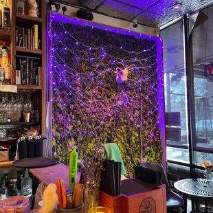 a view of a bar with purple lighting