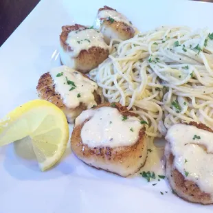 Scallop beurre blanc. Scallops gently sautéed and topped with a white wine butter cream sauce and accompanied with pasta.