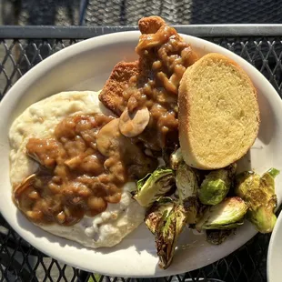 Smothered Pork - breaded pork cutlet smothered in mushroom gravy, garlic mashed potatoes, brussel sprouts, garlic bread.