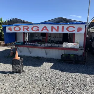 a food stand with a sign that says organic