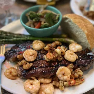a plate of food with shrimp and asparagus