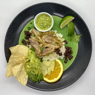 Cuban Mojo Pork - Explosion of citrus flavors served with rice, black beans &amp; side of fresh guacamole,