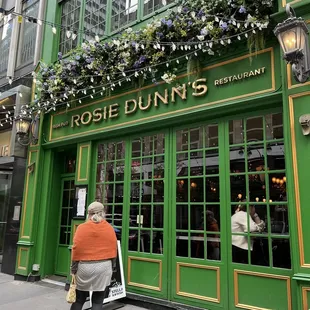 a woman walking in front of a restaurant