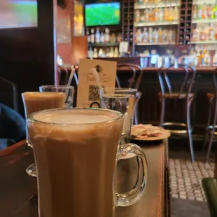 a glass of coffee on a bar