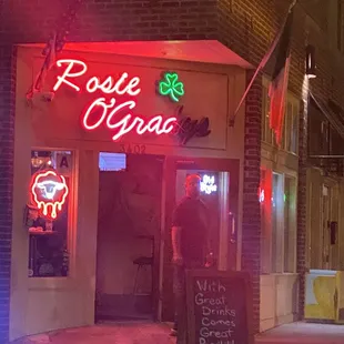 a neon sign in front of a restaurant