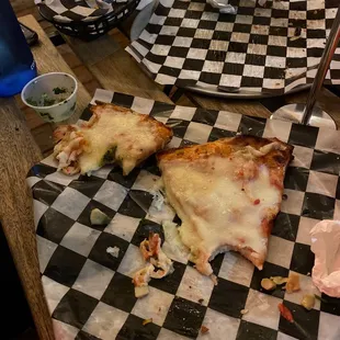 Small mountain of cheese for two small slices. RIP to their cheese budget.