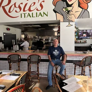  a man sitting in a restaurant