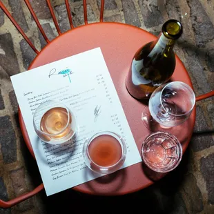 two glasses of wine and a menu