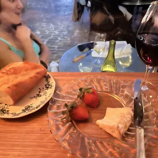 Cheese and fruit with honey and a baguette.