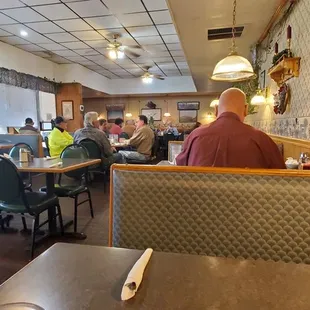 people sitting at tables in a restaurant