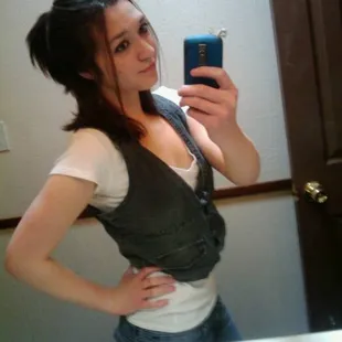 a woman taking a selfie in the mirror