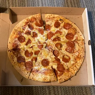 A large pepperoni and pineapple pizza.
