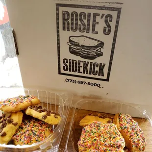 two trays of donuts with sprinkles