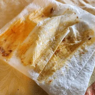 Napkin saturated from the grease of one tamale