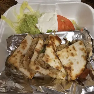 Chicken quesadillas with all of the accoutrements; delivered