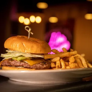 Rosis Burger made with "Escabeche", beef patty, cheddar cheese, lettuce, pickled onions, our chileancho mayo on a brioche bun!