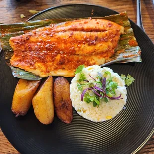 Barramundi fish with plantains and white rice.