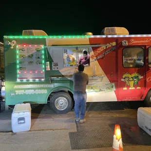 a man standing in front of a food truck