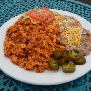 Chorizo con Huevo served with beans and tortillas.