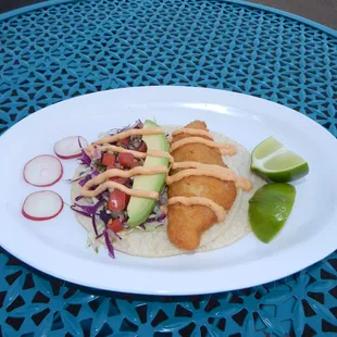 Fish Taco-Corn tortilla filled with crispy battered Cod Filet, topped with shredded cabbage, fresh salsa, avocado and Chipotle Lime sauce