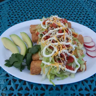 Shredded Beef or Shredded Chicken Taquitos topped with lettuce, cheese,sour cream, fresh salsa and avocado