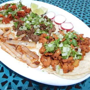 Tacos- Choice of Carne Asada, Al Pastor, Shredded Beef, Shredded Chicken, Grilled Chicken or Chorizo, topped with onions and cilantro.