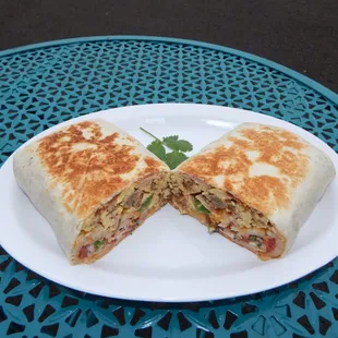 Hearty Breakfast Burrito- filled with scrambled eggs, hash browns, ham, sausage, bacon, onions, peppers, cheese and fresh salsa.