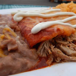 Enchilada Plate- your choice of Shredded Chicken or Shredded Beef Enchiladas served with rice and beans.