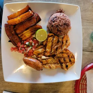 "Typical" chicken breast with sausage, beans and rice, plantains and pico de gallo!
