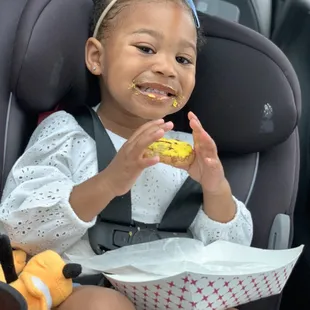 My daughter with all the icing on her mouth from her Smiley Face Cookie
