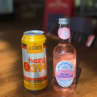 a bottle of lemonade and a can of honey soda
