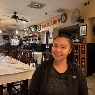 a woman sitting at a table in a restaurant