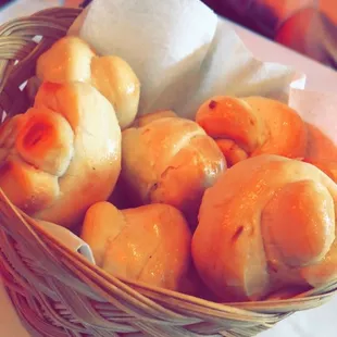 a basket of bread rolls on a table