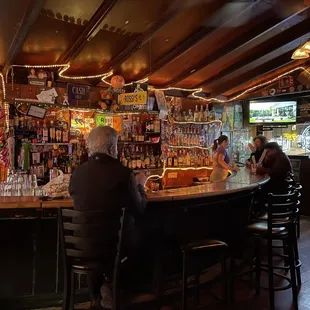 two men sitting at a bar
