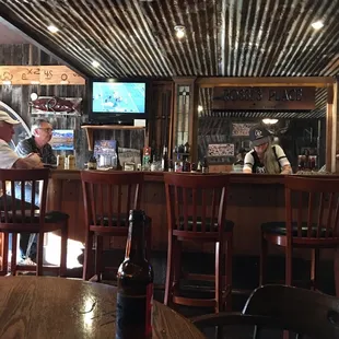 a bar with people sitting at the bar