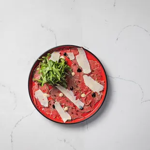 BEEF CARPACCIO
 Grass-fed Thinly Sliced Raw Beef, Worcestershire Aioli, Shaved Parmigiano, Arugula, Balsamic Glaze